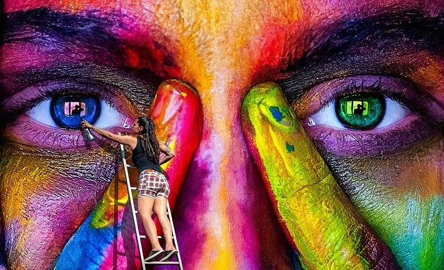 A large colorful mural of a face for the article "The Power of RE"